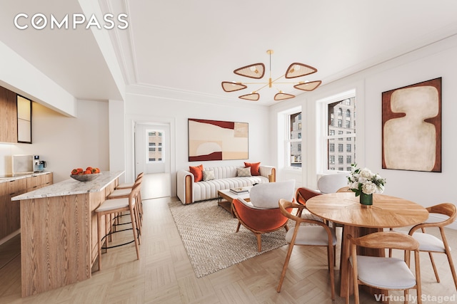 dining space with an inviting chandelier and ornamental molding