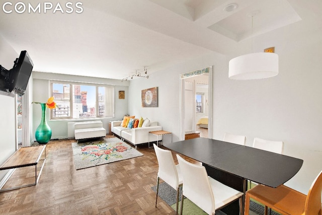 dining area featuring parquet flooring