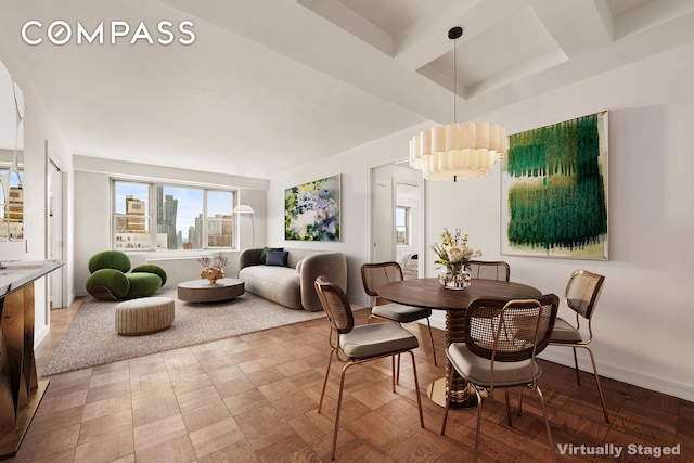 dining room with beamed ceiling, a view of city, and baseboards