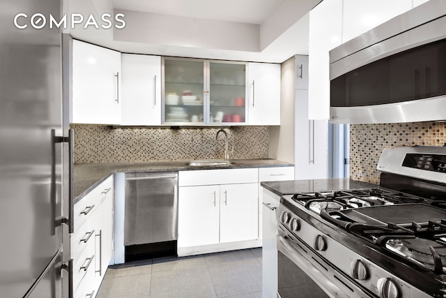137 E 36th St Unit 16B, New York City, NY 10016 - kitchen featuring appliances with stainless steel finishes, white cabinetry, a sink, and tasteful backsplash