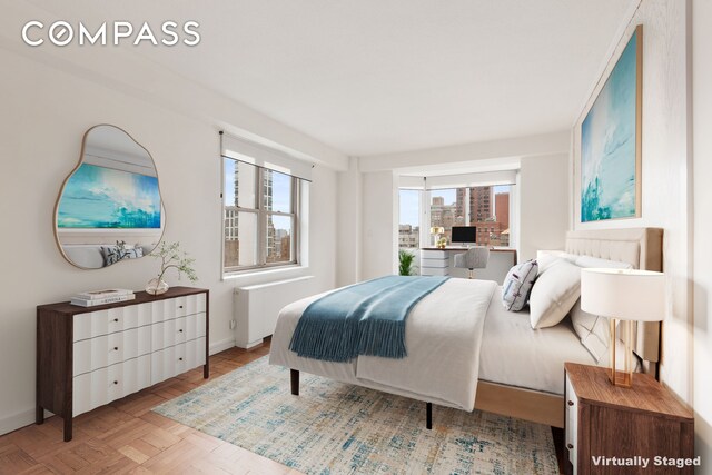 bedroom featuring radiator and baseboards