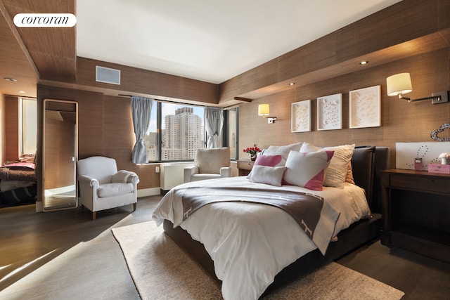 bedroom featuring wood finished floors and visible vents