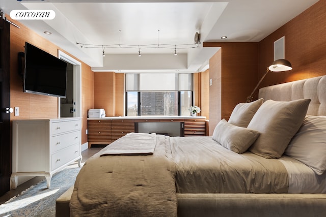 bedroom featuring visible vents and track lighting