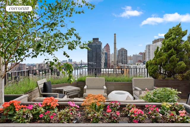 view of patio with fence and a city view