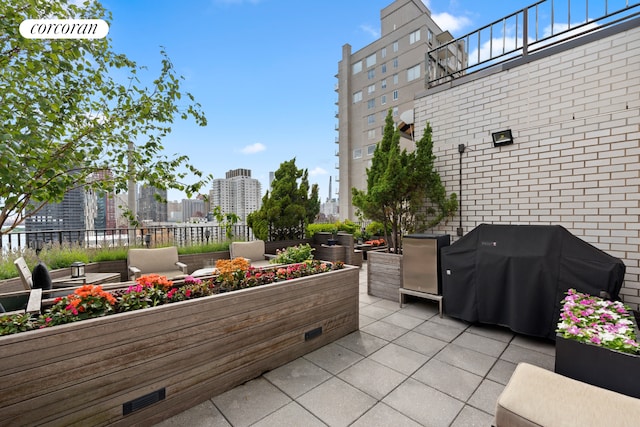 view of patio featuring a view of city, fence, and area for grilling