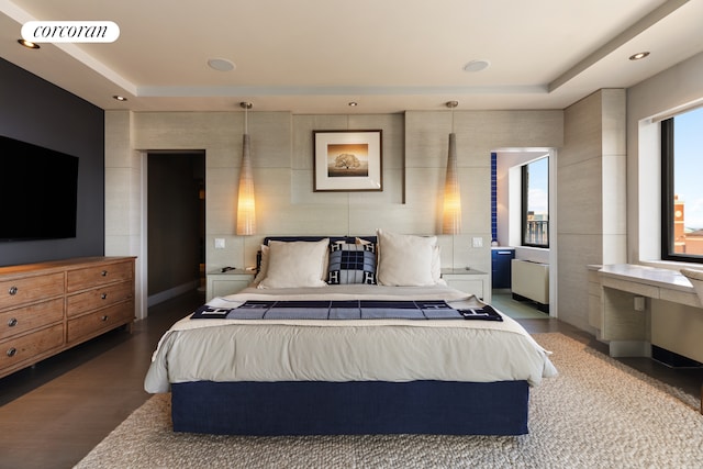 bedroom featuring light wood finished floors, visible vents, a tray ceiling, and recessed lighting