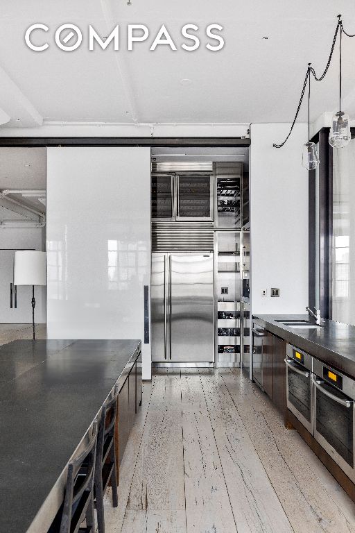 kitchen featuring sink, wood-type flooring, and stainless steel appliances