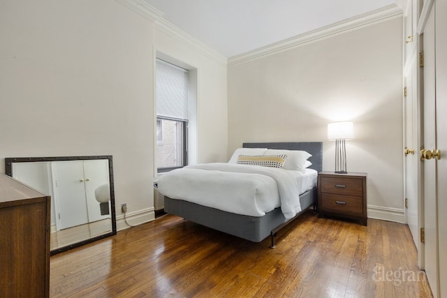 bedroom featuring wood-type flooring and crown molding