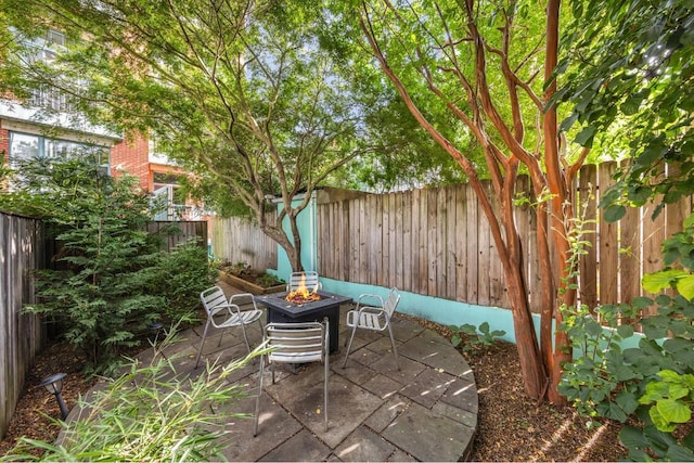 view of patio / terrace with an outdoor fire pit