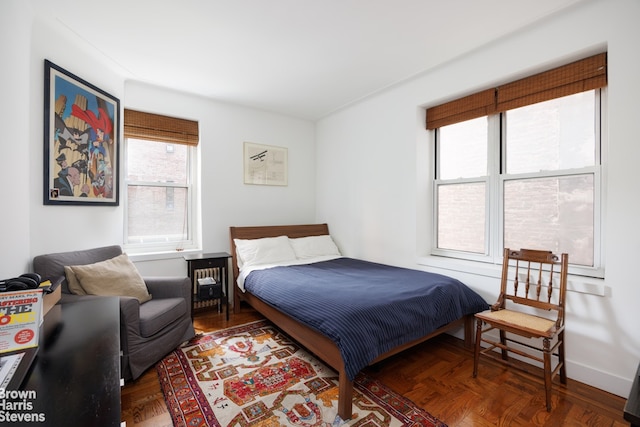 bedroom with dark parquet floors