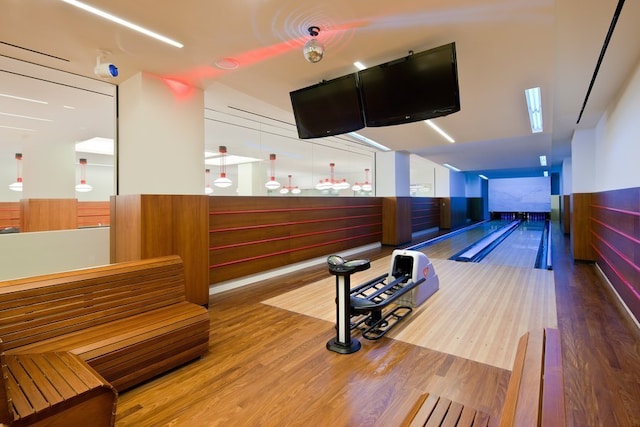 game room with a bowling alley and wood finished floors