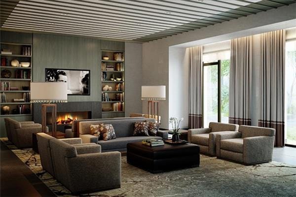 living area featuring built in features and a lit fireplace