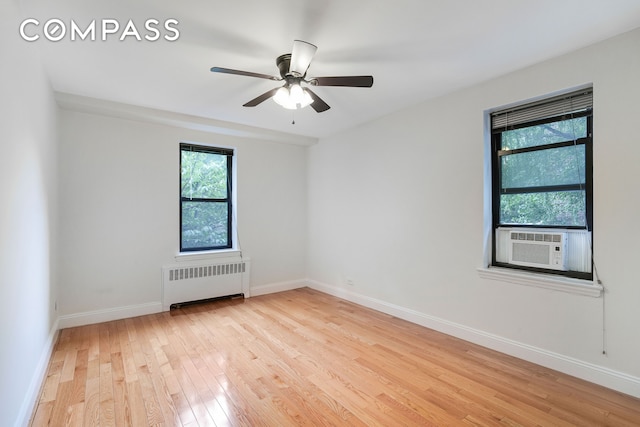3840 Greystone Ave Unit 1K, New York City, NY 10463 - spare room with radiator, light wood-style flooring, a ceiling fan, and baseboards