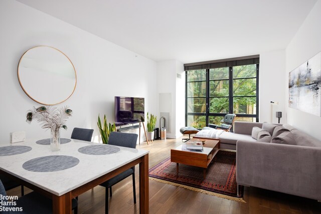 living room featuring floor to ceiling windows and hardwood / wood-style floors