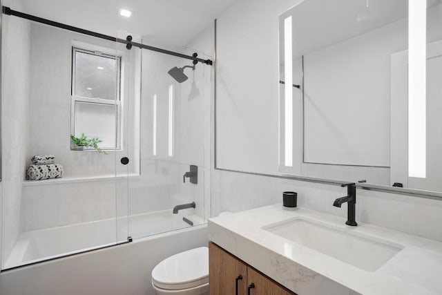 full bathroom featuring enclosed tub / shower combo, vanity, and toilet