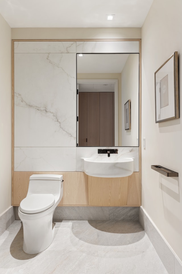 77 Greenwich St Unit 26C, New York City, NY 10006 - bathroom featuring toilet, baseboards, and vanity