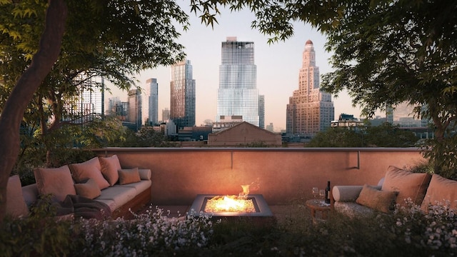 patio terrace at dusk featuring an outdoor living space with a fire pit