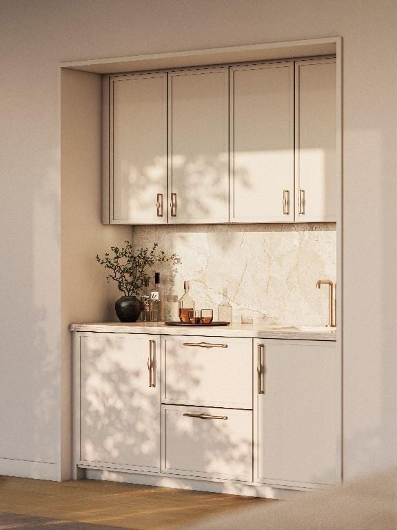 bar featuring wood-type flooring, sink, and decorative backsplash