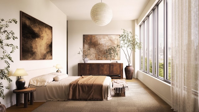 bedroom featuring baseboards and wood finished floors