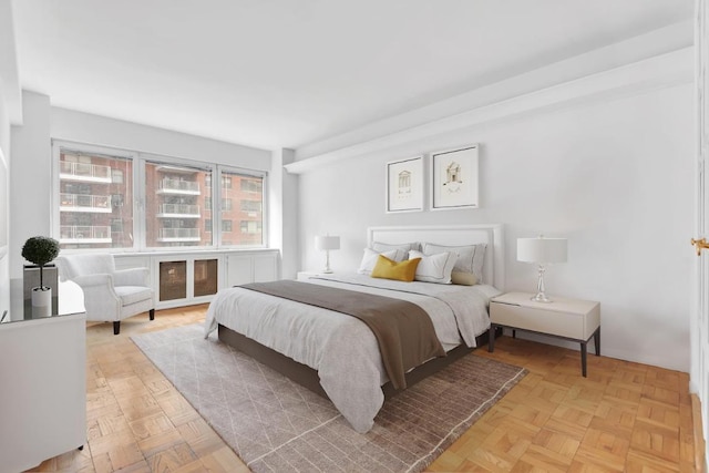 bedroom with light parquet flooring