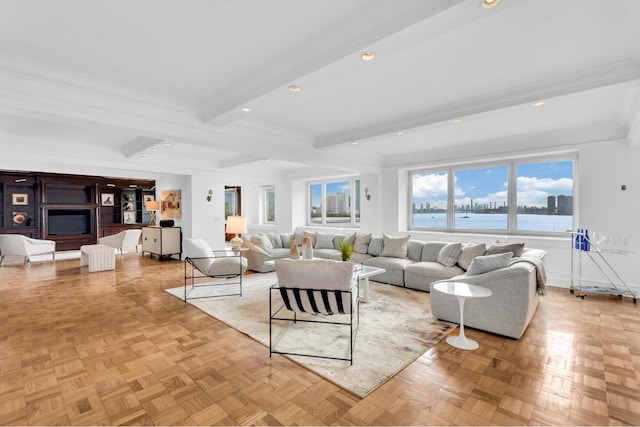 living room with a water view, beamed ceiling, and light parquet floors