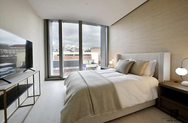 bedroom featuring access to exterior and expansive windows