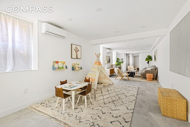 dining area featuring an AC wall unit and baseboards