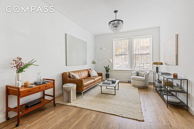 living room featuring wood-type flooring and a notable chandelier