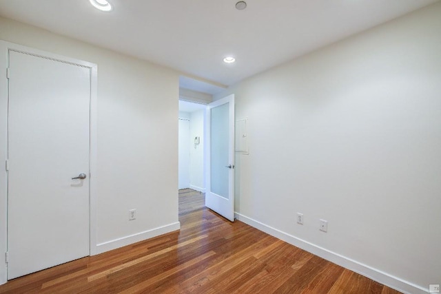 unfurnished bedroom with hardwood / wood-style flooring