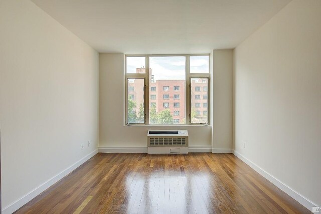 unfurnished bedroom with dark hardwood / wood-style flooring