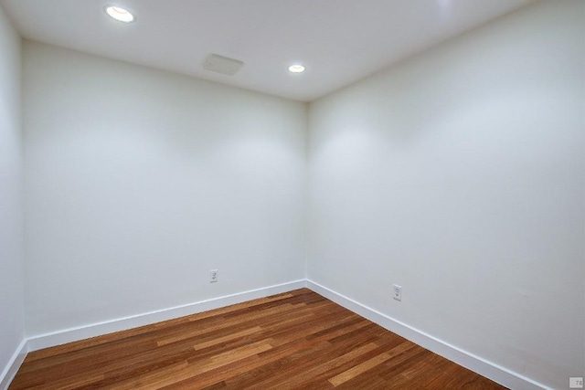 unfurnished room featuring hardwood / wood-style flooring