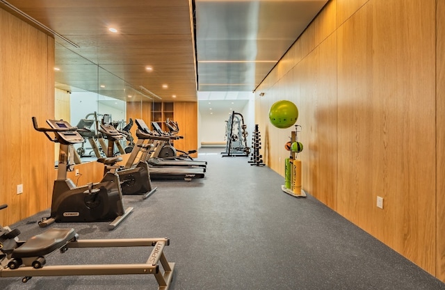 workout area featuring wood walls