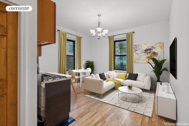 living room featuring a chandelier and light hardwood / wood-style flooring