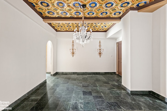 unfurnished dining area with a chandelier and crown molding