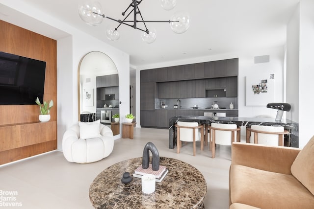 living room featuring an inviting chandelier and sink