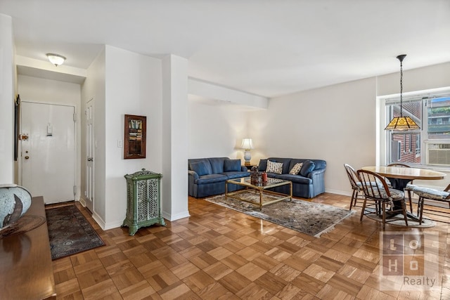 living area featuring baseboards