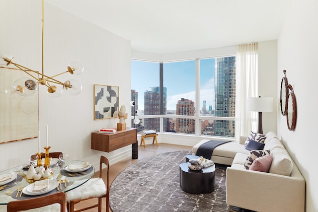 living area featuring a view of city, wood finished floors, and an inviting chandelier