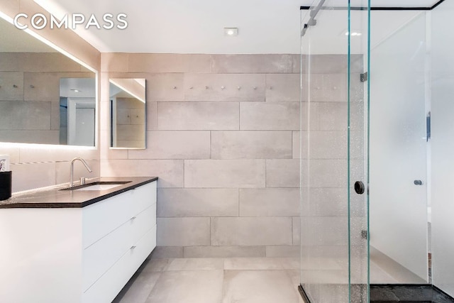 bathroom with vanity and an enclosed shower