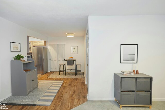 hallway with light hardwood / wood-style flooring