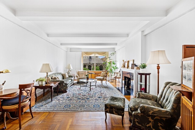 living room featuring parquet floors, a premium fireplace, and beam ceiling