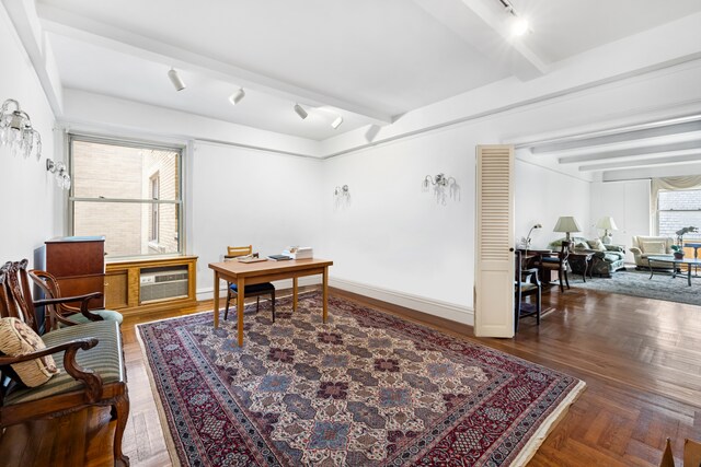 office area with beam ceiling, track lighting, and a wall unit AC