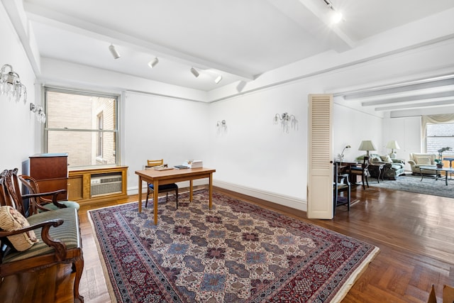 office featuring baseboards, a wall unit AC, beam ceiling, and track lighting