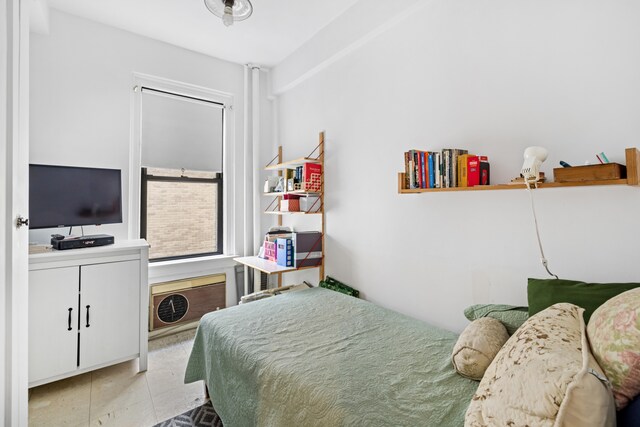 carpeted bedroom with ceiling fan, beam ceiling, and a baseboard radiator