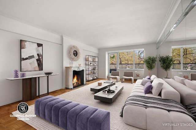 living area with a warm lit fireplace and ornamental molding