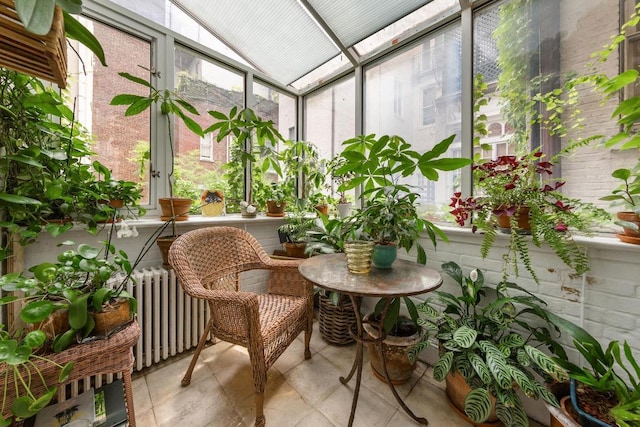 sunroom with lofted ceiling and radiator