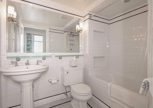 bathroom featuring shower / bath combo with shower curtain, tile walls, toilet, and crown molding