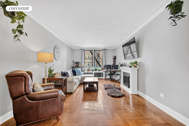 living area with baseboards, a fireplace, and ornamental molding