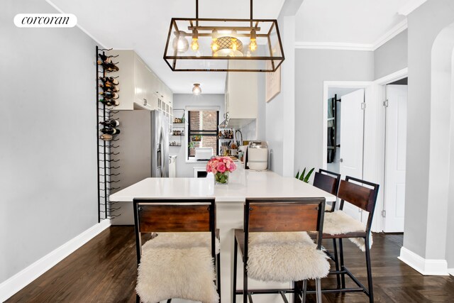 72-11 110th St Unit 4A, New York City, NY 11375 - dining area featuring baseboards, ornamental molding, dark wood-type flooring, and a notable chandelier