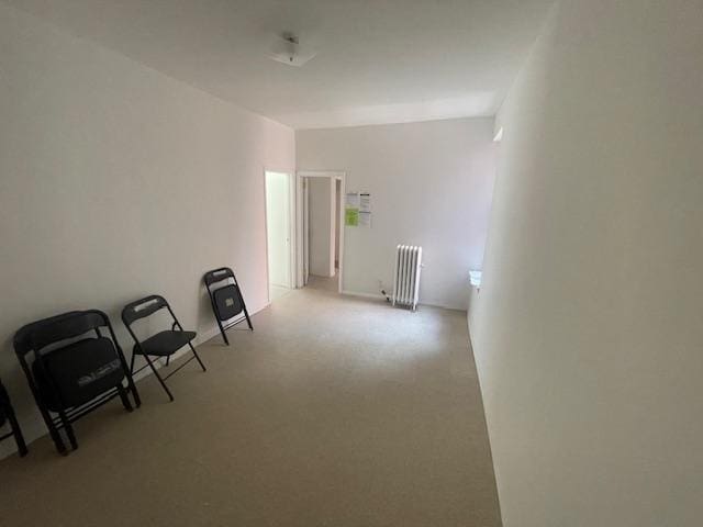 546 W 156th St Unit 11, New York City, NY 10032 - unfurnished room with radiator heating unit and carpet