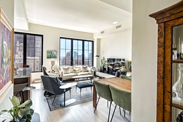 living room featuring visible vents and hardwood / wood-style floors